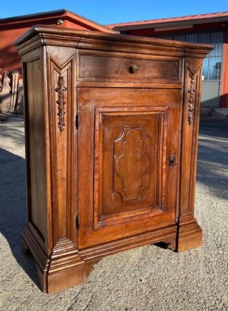 Small solid walnut sideboard with caryatid sculptures on the front and door panel.