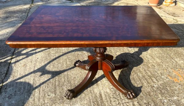Large mahogany dining table with floral decoration