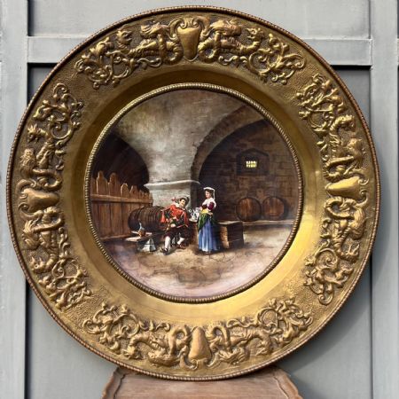 Ceramic plate within a frame in embossed gilded copper
