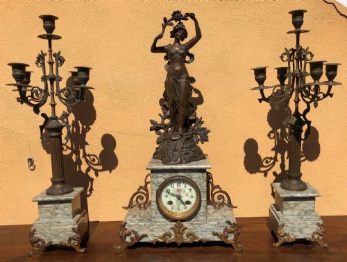 Triptych: clock and two candlesticks