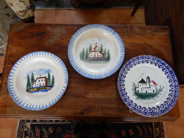 three plates with small houses