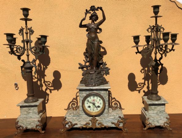triptych: clock and two candlesticks
    